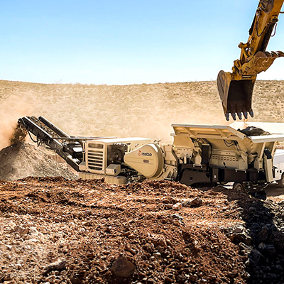 crushing equipment being loaded by excavator